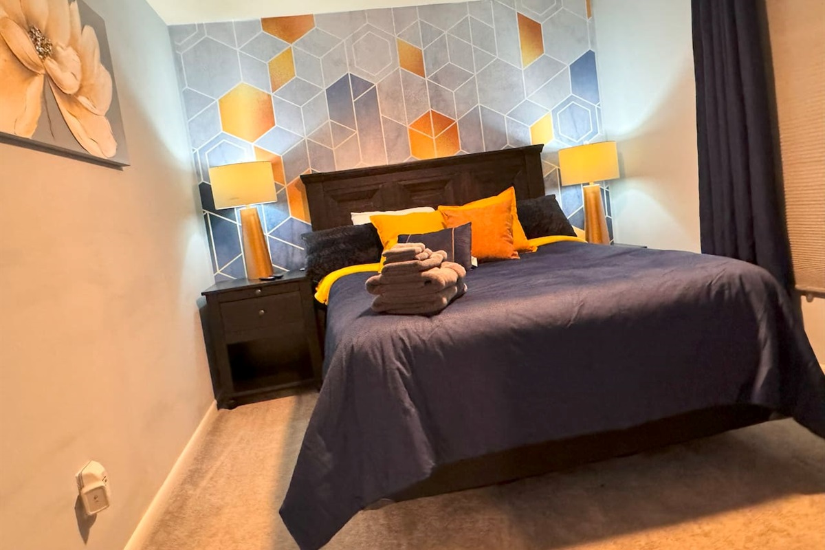 Queen-sized bed.  This riin also includes blackout curtains, a full-length mirror, 43” TV, Closet, side chair, and table, as well as USB and USB-C charging ports.