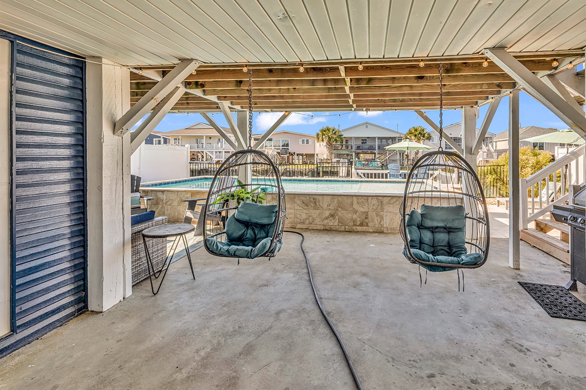 Cozy hanging chairs, great for lounging by the pool.