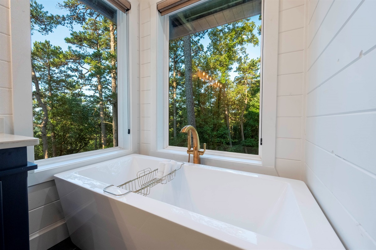 Relaxing soaking tub surrounded by peaceful woodland scenery