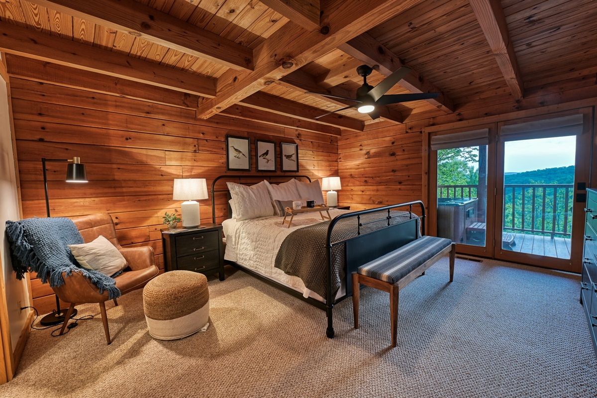 Main level master bedroom with king size bed, 43 inch Roku tv, and night stands with built in plug ins.