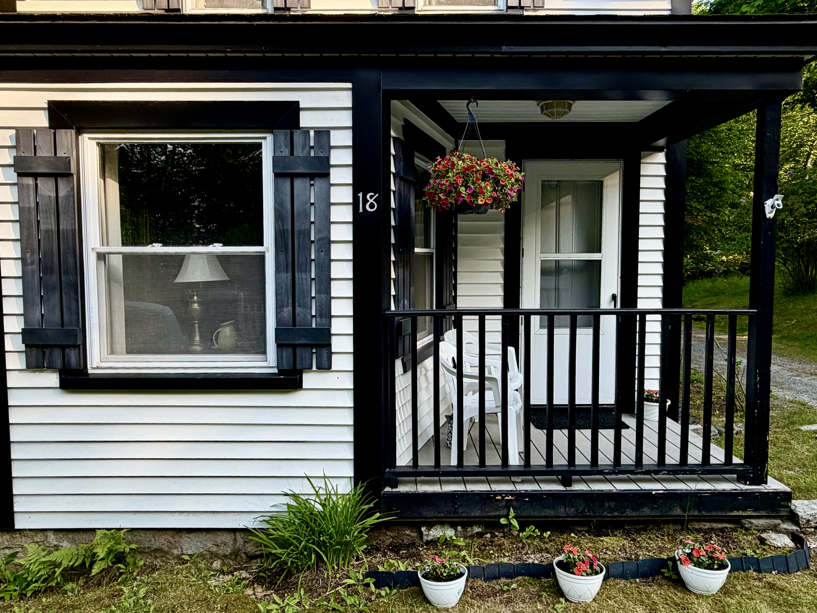 Start your morning with coffee on the front porch, surrounded by summer blooms. This cozy seating area perfectly captures the quiet, slow-paced charm of Somesville’s historic district. A peaceful spot to plan your day's Acadia adventures.