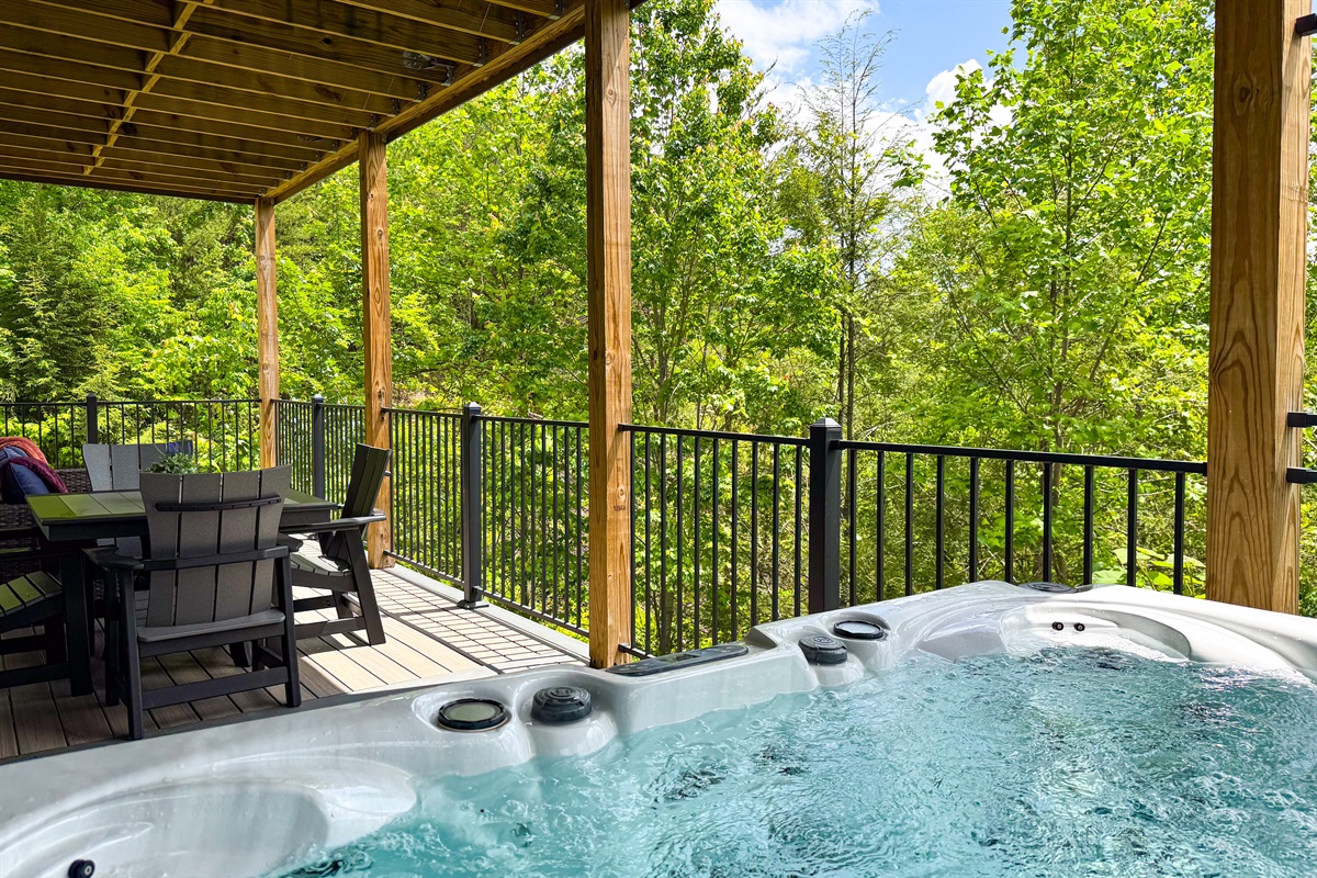 Stay in the conversation while enjoying a well-earned soak in the hot tub; the nearby cafe table and even the outdoor sofa offer a place for a whole group to be together!