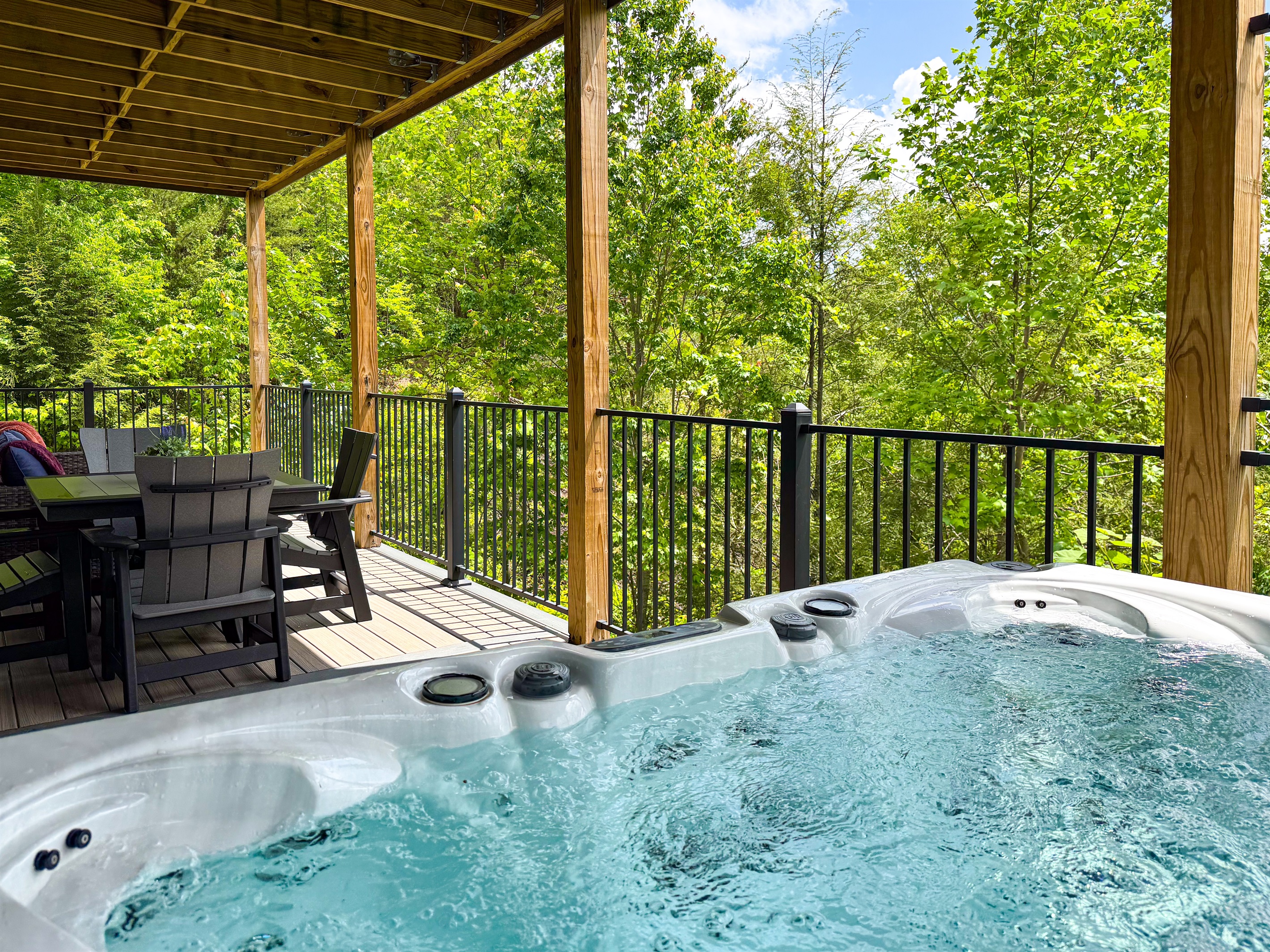 Stay in the conversation while enjoying a well-earned soak in the hot tub; the nearby cafe table and even the outdoor sofa offer a place for a whole group to be together!