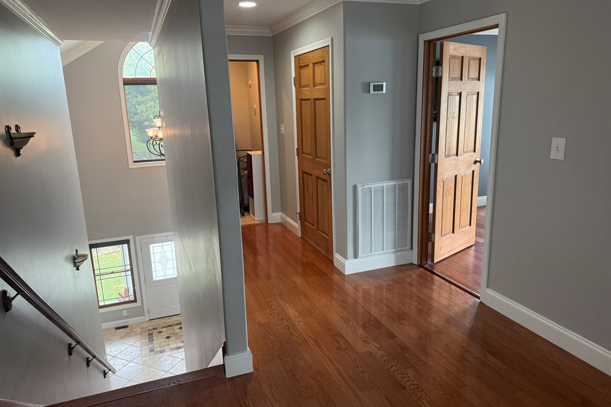 Upstairs hallway with a view into laundry room, linen closet and Bedroom 1