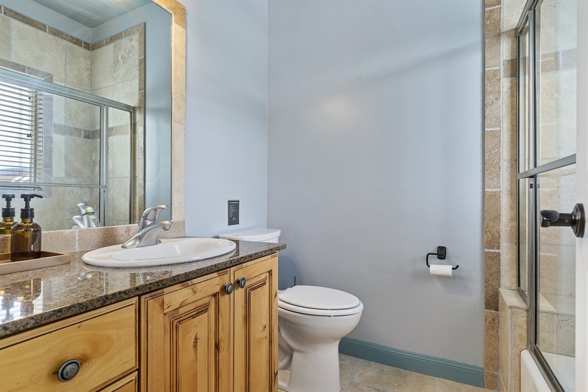 A full bathroom featuring a clean, modern design with a shower/tub combination and quality finishes throughout.