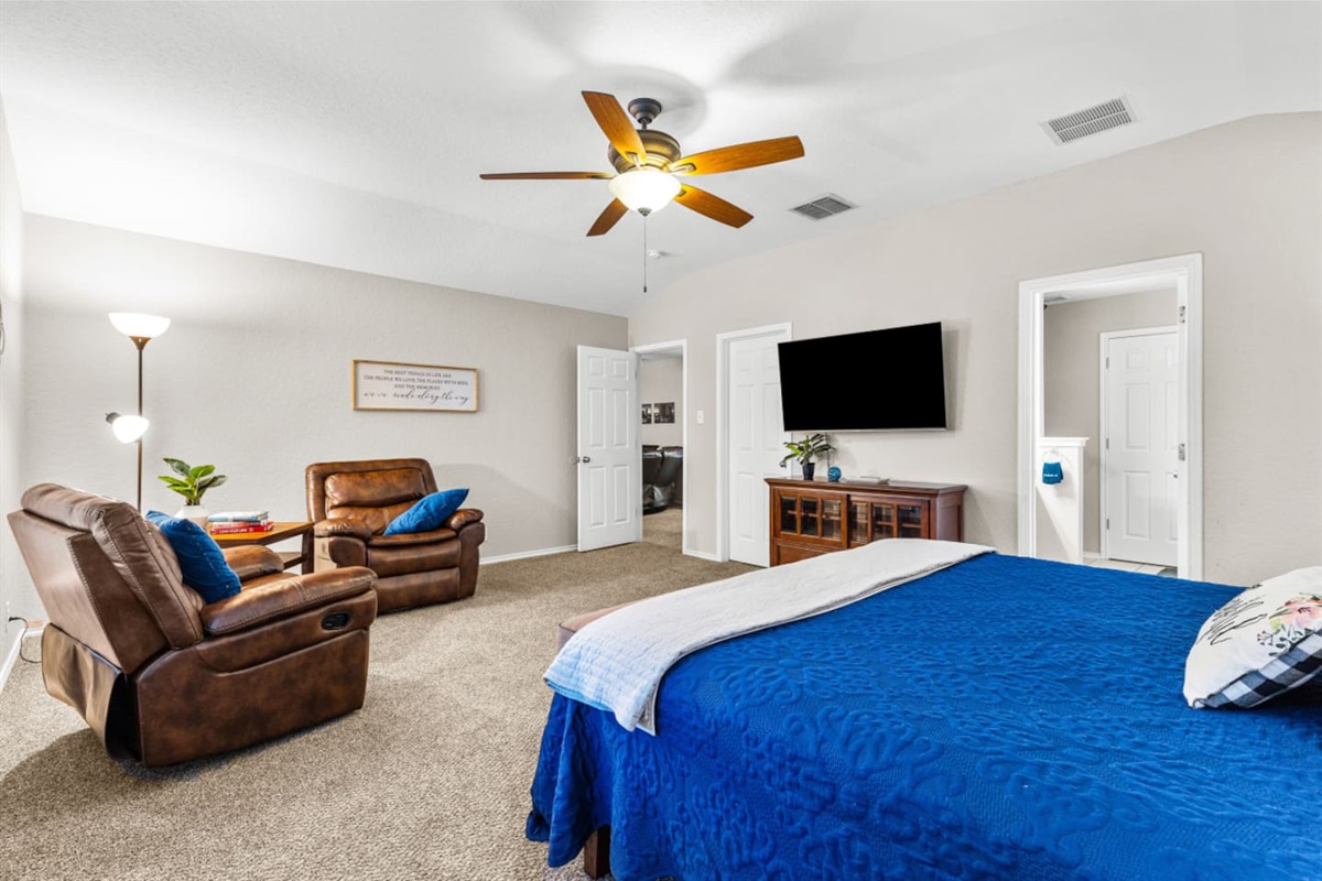 Oversized primary suite featuring a king bed, cozy reading nook, blackout shades, premium bedding, and a streaming-ready Smart TV for the perfect unwind.
