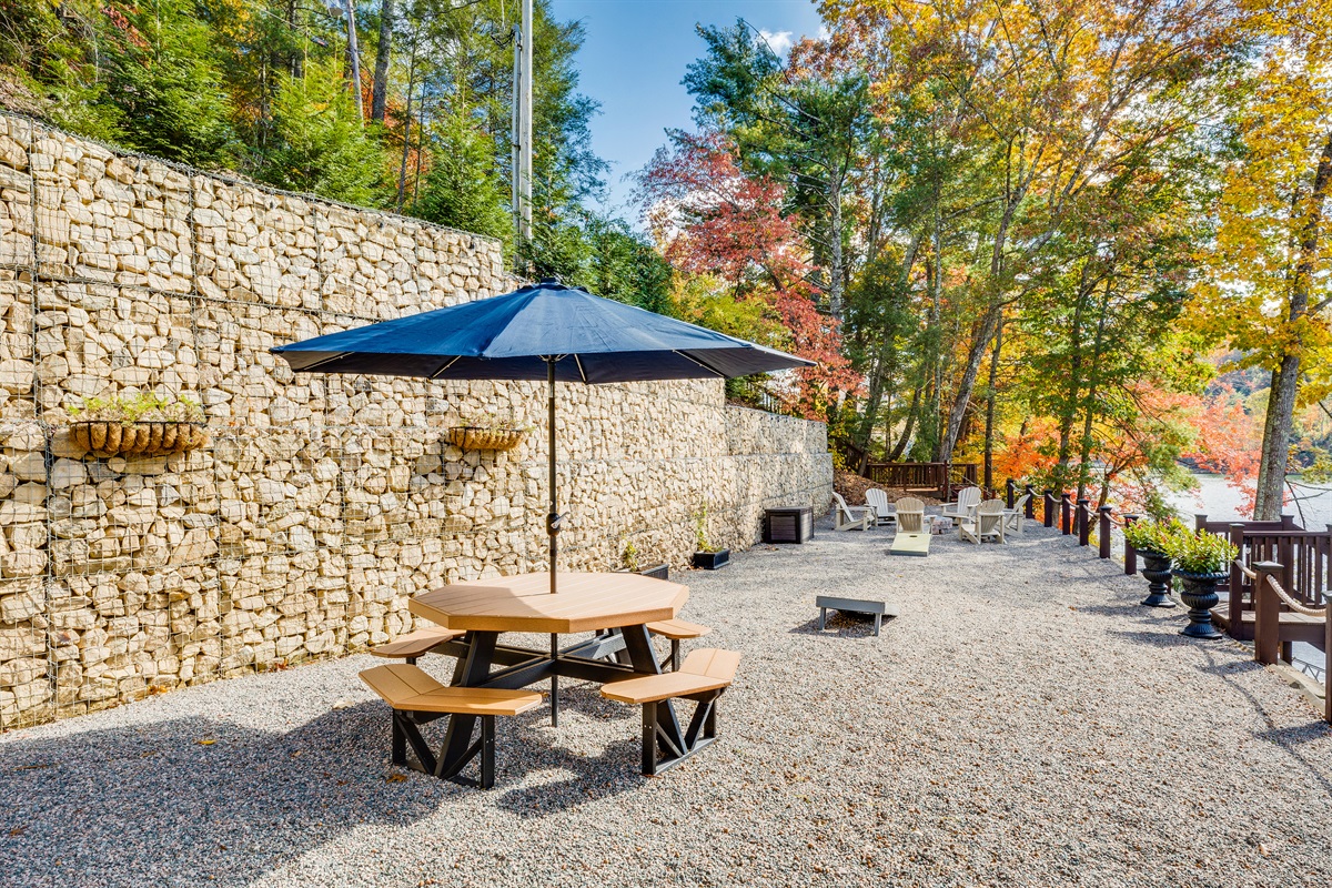 Picnic table with umbrella, room for corn hole boards and fire pit