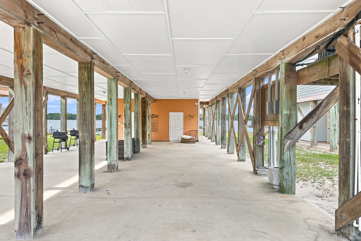 Large shaded area beneath the home — ideal for boats and outdoor hangs