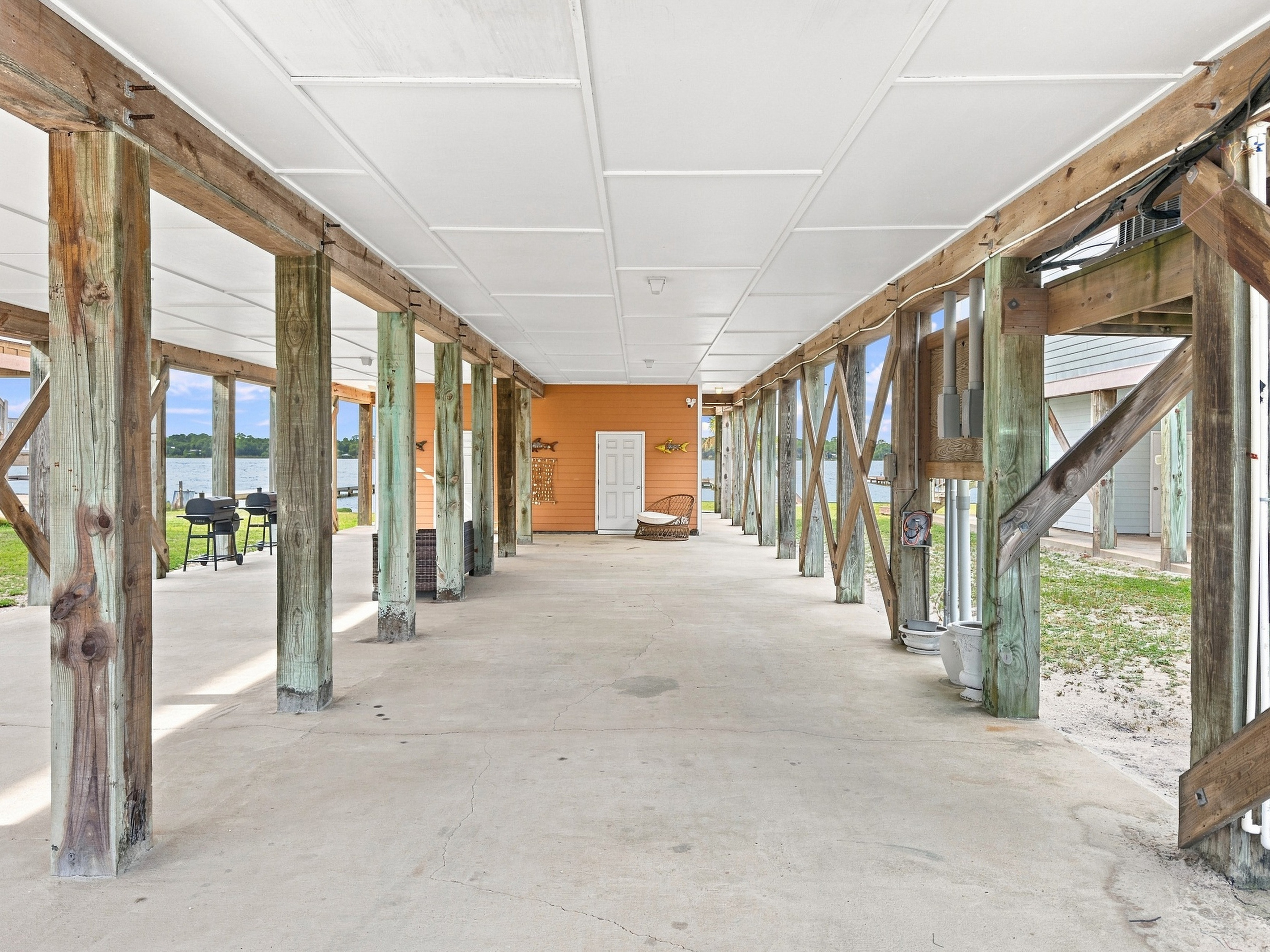 Large shaded area beneath the home — ideal for boats and outdoor hangs