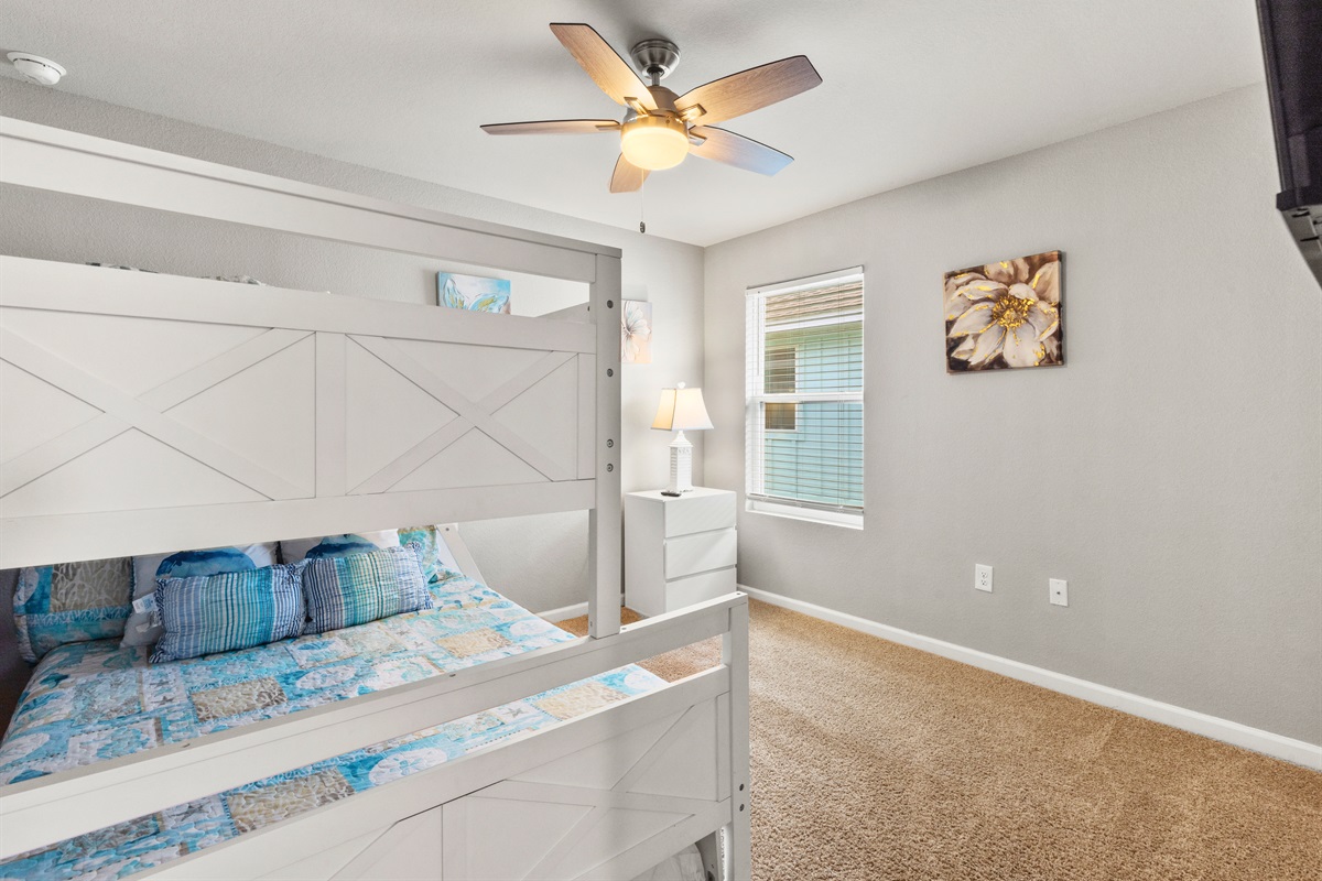 Coastal-inspired bunk room with cheerful bedding and room to spread out.