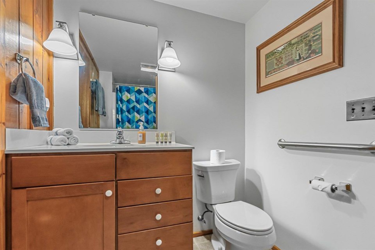 The large jack-n-jill bathroom has a full bathtub with shower. Support railing is also handy when needed.