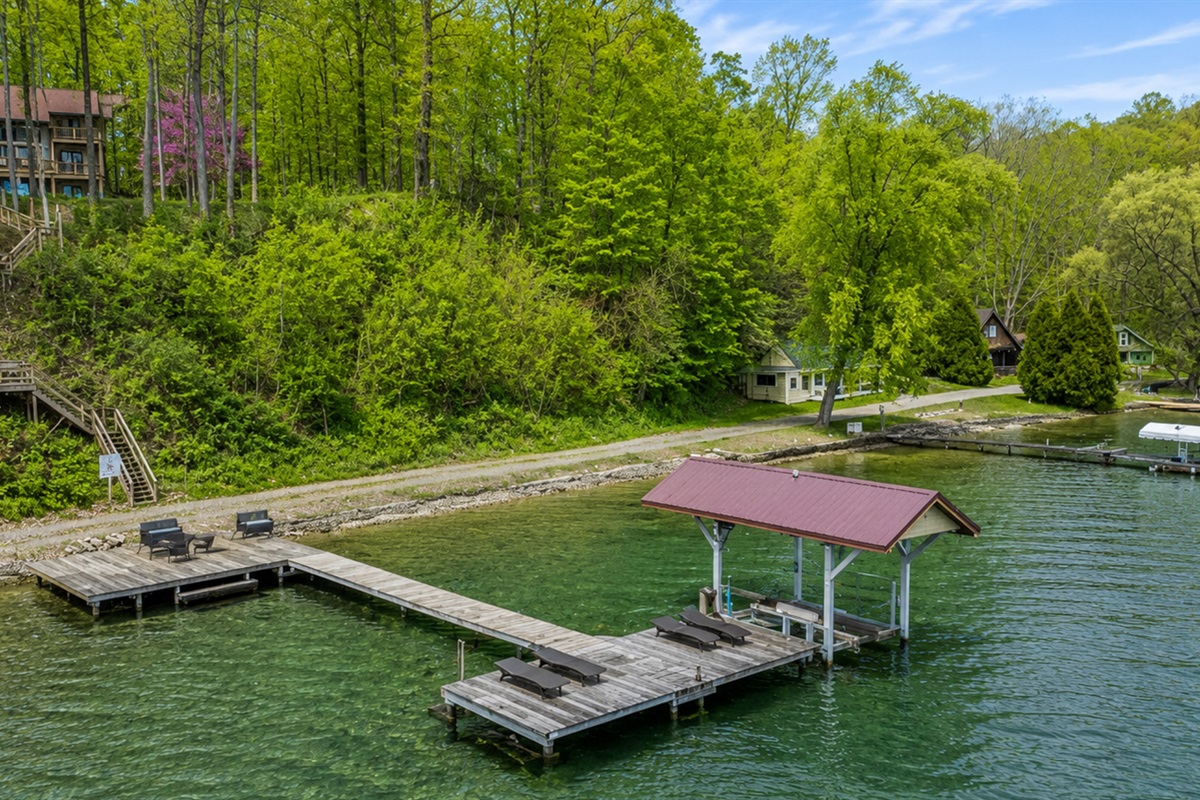 Wooded hillside leads down private steps to the dock on crystal-clear Cayuga Lake—tie up the boat, swim, or soak in Finger Lakes sunsets 🚤🌞🌊Hoist not available