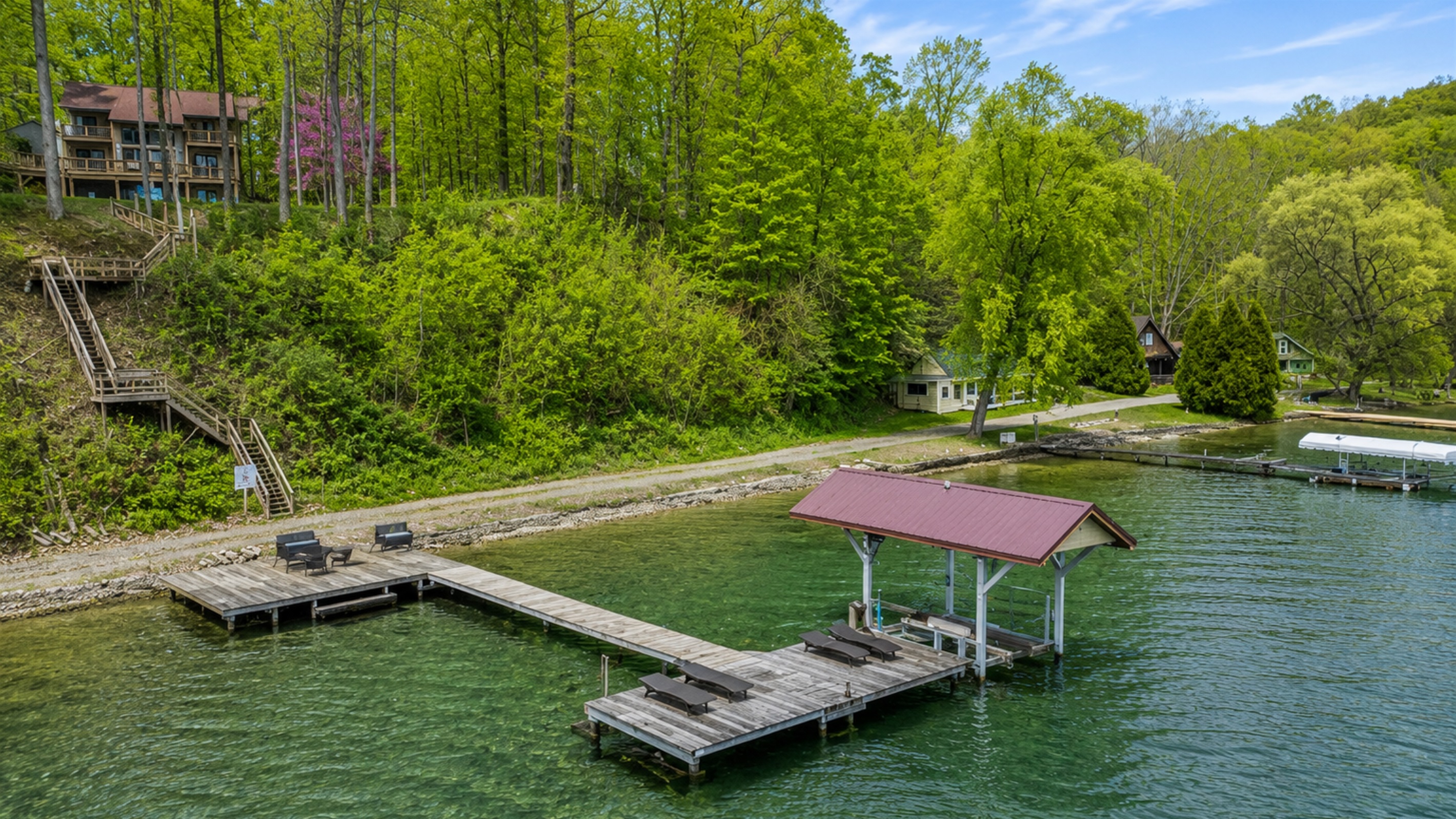 Wooded hillside leads down private steps to the dock on crystal-clear Cayuga Lake—tie up the boat, swim, or soak in Finger Lakes sunsets 🚤🌞🌊Hoist not available