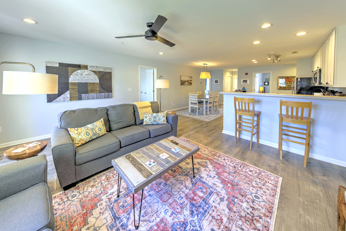 Living Room: Bright and airy space perfect for unwinding after a day at the beach with stylish decor and inviting seating!
