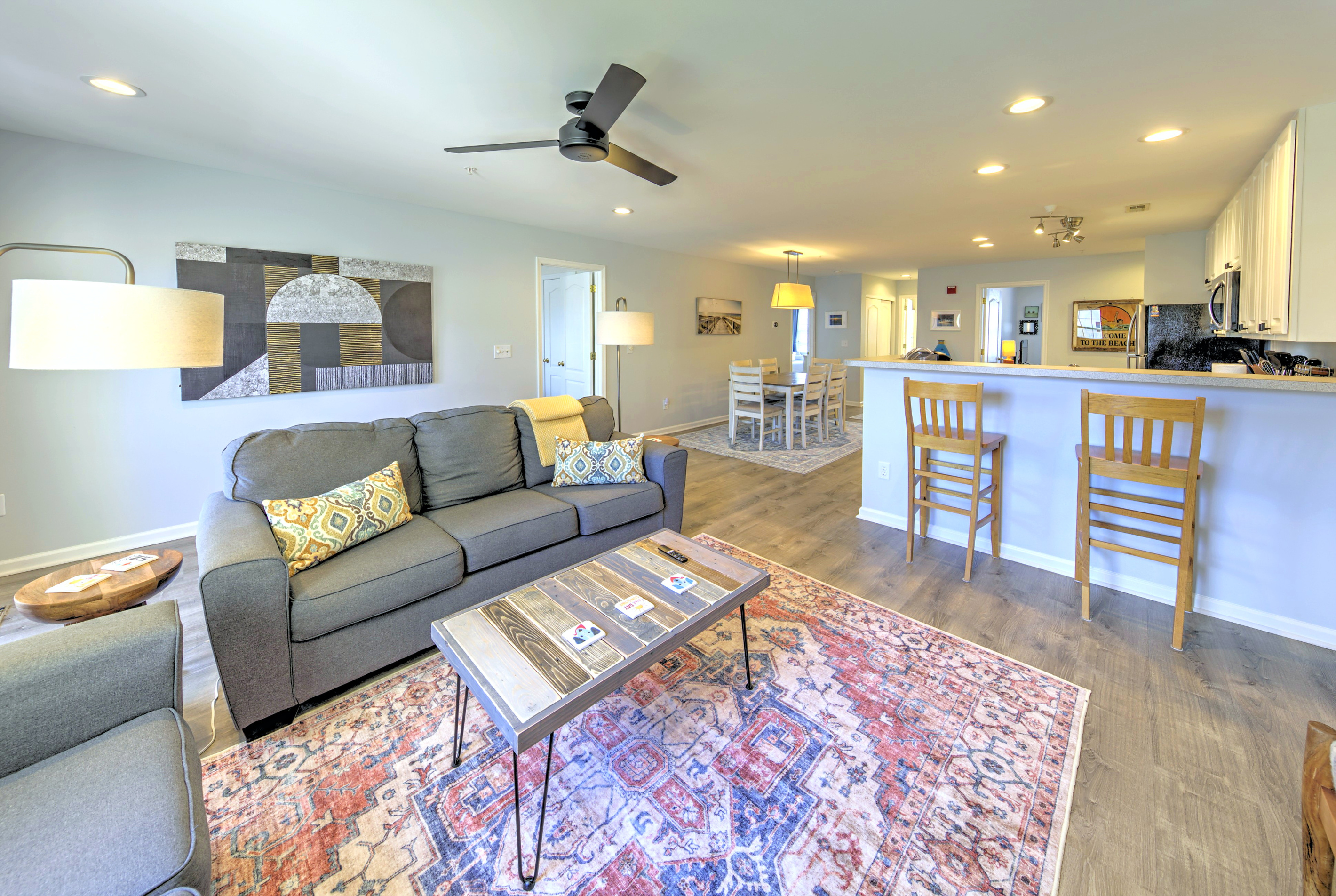 Living Room: Bright and airy space perfect for unwinding after a day at the beach with stylish decor and inviting seating!