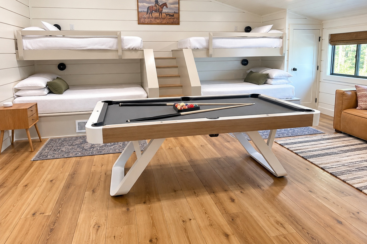 The ultimate bunk room for kids and adults alike - two queen and two twin beds, easy stair access to top bunks, and a modern leather couch for watching movies or just simply relaxing during your stay.