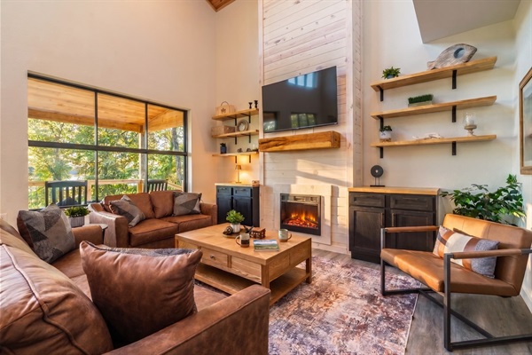Great room with leather seating, electric fireplace, and smart TV, the after-dinner gathering spot.