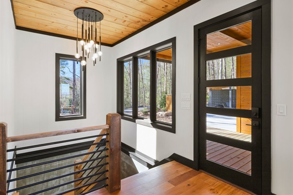 Natural light floods this airy landing, where rustic meets modern and every window frames the forest outside.
