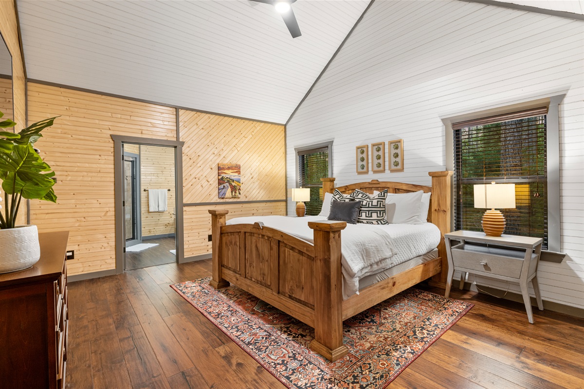Acadia King Suite: Serene retreat, inviting atmosphere. The ceiling gracefully rises like a mountain peak, while natural light streams in, creating a unique and enchanting experience.
