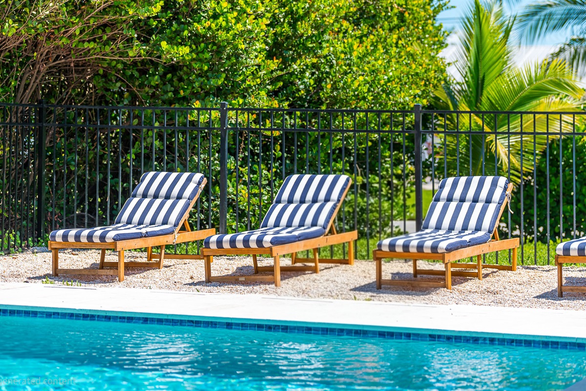 The pool deck is finished in shell white limestone, offering a beautiful natural backdrop.  By night, enjoy the tiki bar, TV, fire table, and the glow of the Jupiter Lighthouse Beacon 