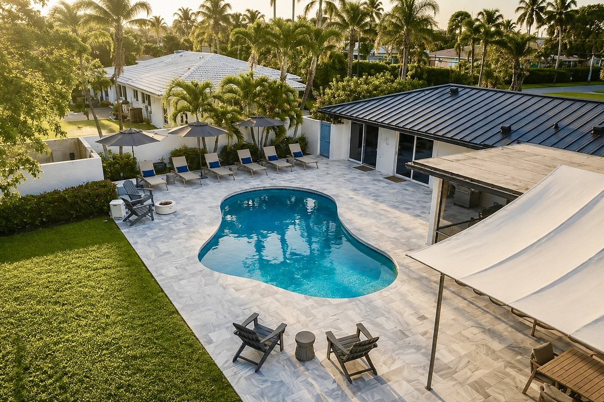 From above, Oasis Palms shows off its private pool, covered patio, open lawn, and tropical setting for a relaxed Delray Beach escape.