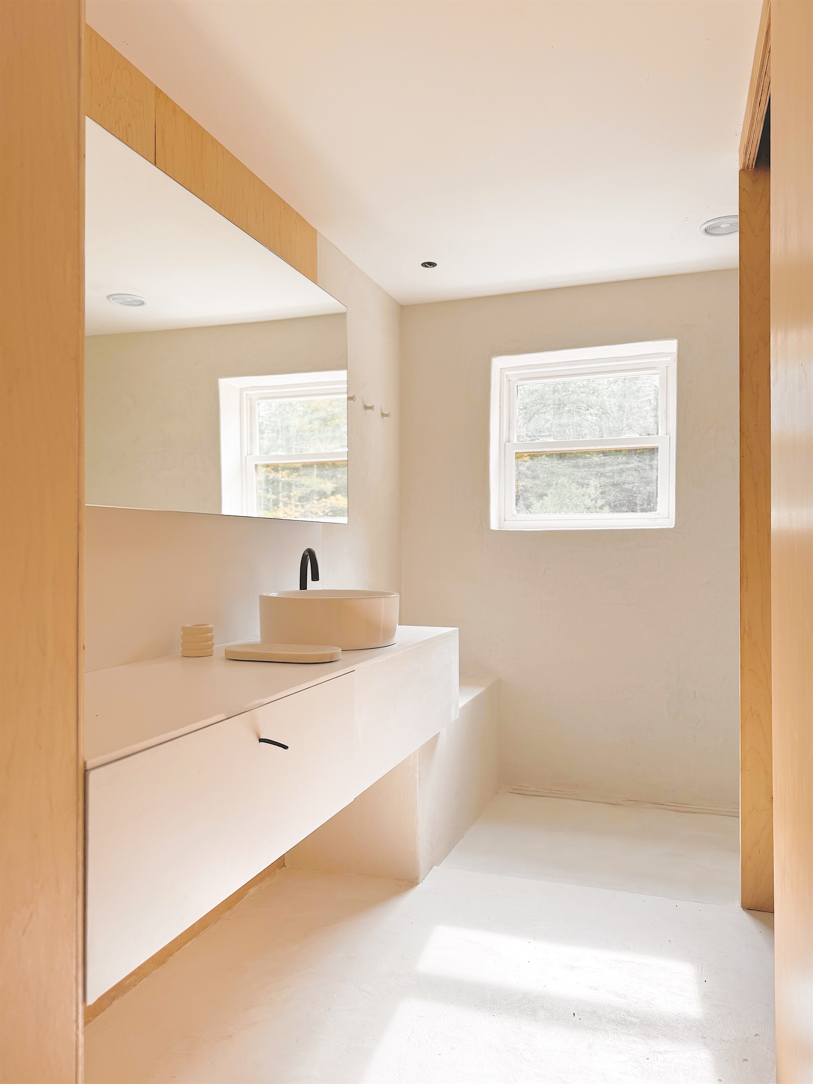 The full bathroom is located upstairs, and features an open microcement shower, and enclosed toilet room.