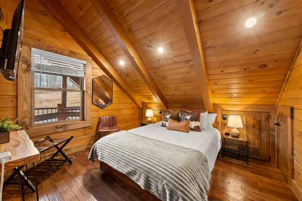 Upper Level Bedroom with Slanted Wood Ceiling, Front-Facing Sunset Views, Smart TV, and White Noise Machine.