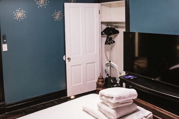 55" Roku tv, extra linens, closet with steamer and ironing board, hangers.