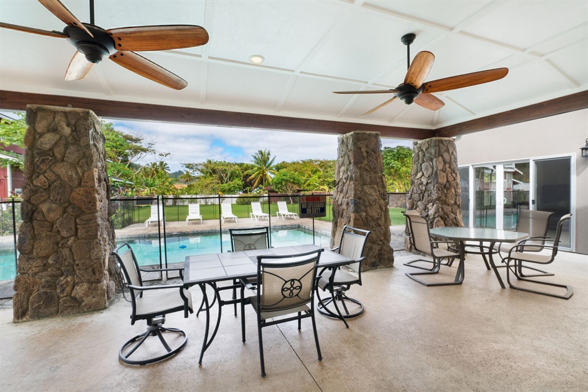 Outdoor patio with 2 tables and plenty of seating
