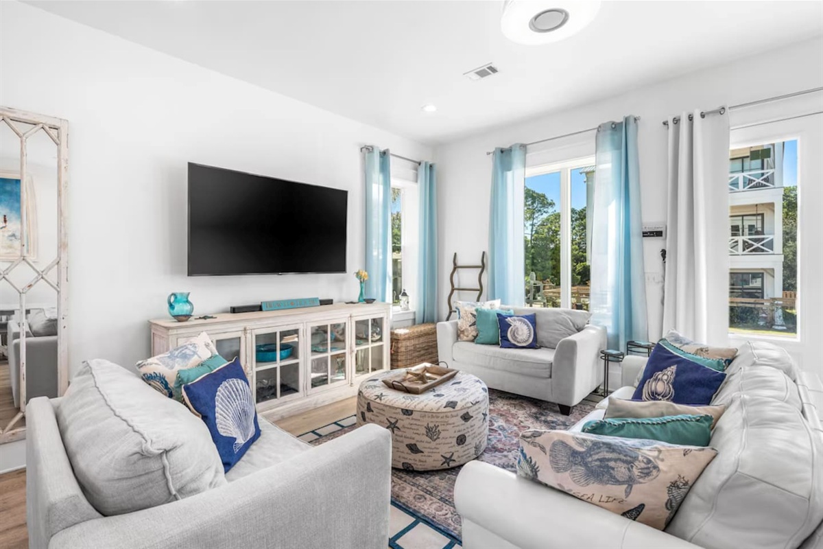 Bright, open-concept living designed for relaxation, complete with a Feng Shui fountain  and an extra-large Smart TV with a soundbar for the ultimate movie night. The sofa is a high-quality queen-size memory foam pull-out.