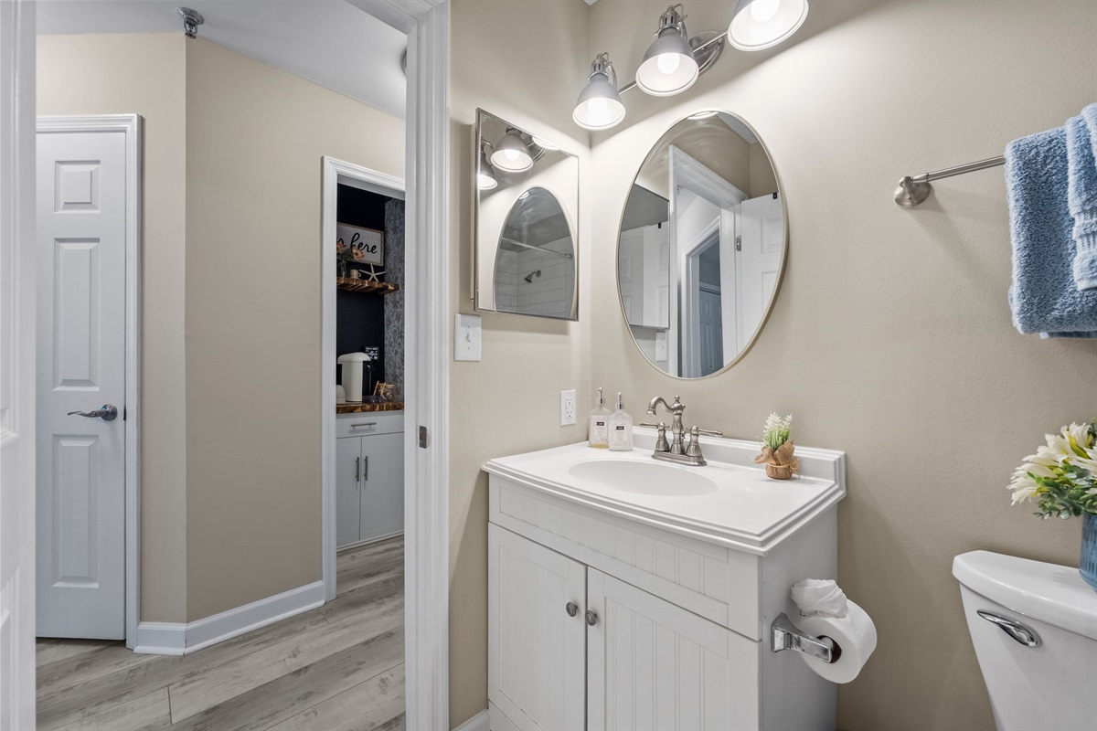 Clean master bathroom with updated lighting and vanity