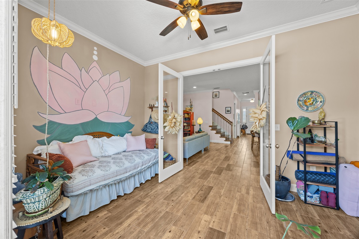 Peaceful wellness‑inspired room with lotus mural and daybed — perfect for yoga, reading, or extra guests.