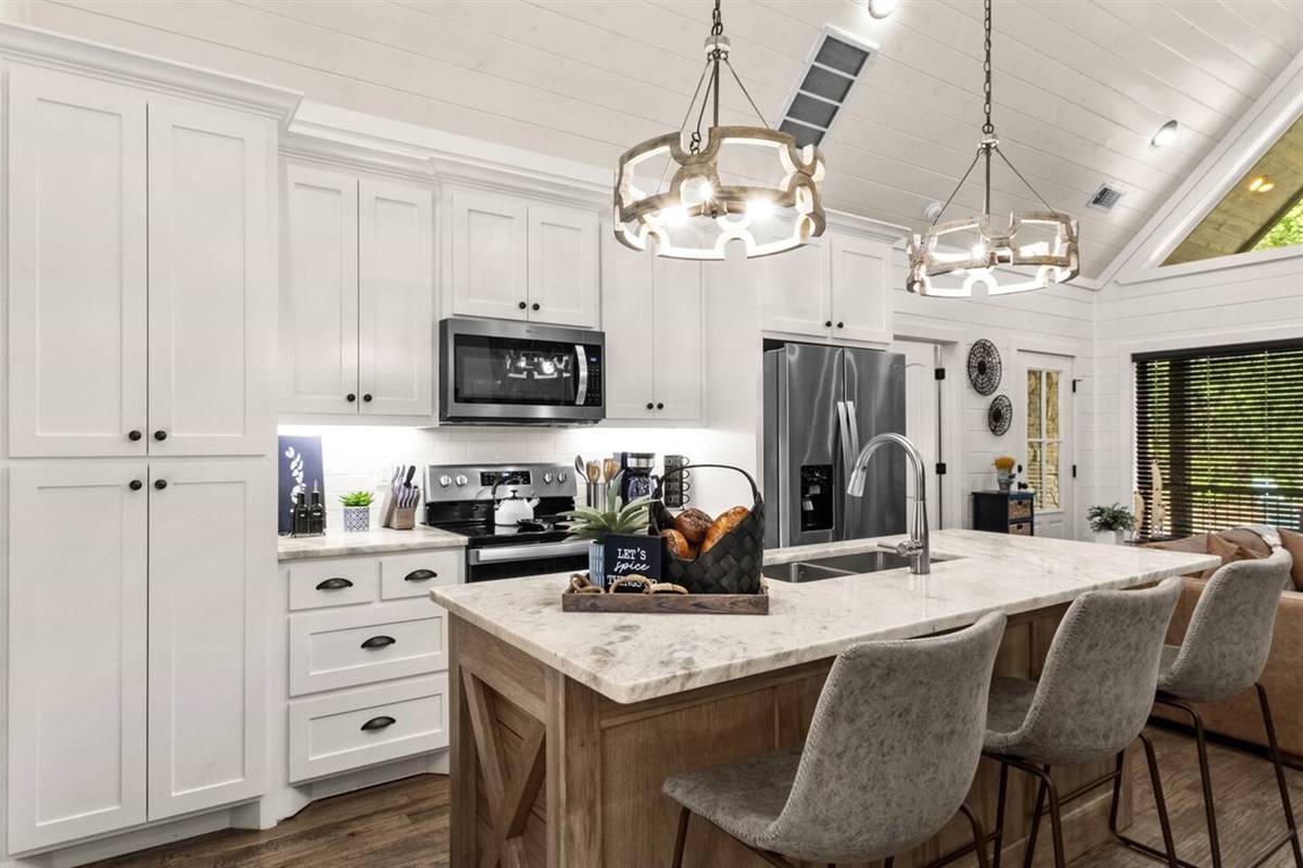 Granite counters offer both beauty and durability, making meal prep a breeze in this bright, open kitchen space.