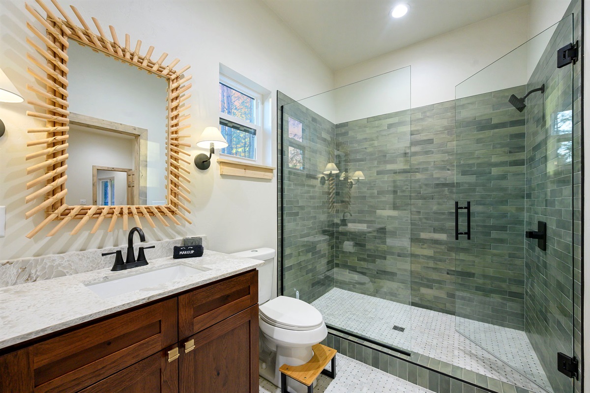 Spacious glass walk-in shower with modern tile and rainfall head 🚿