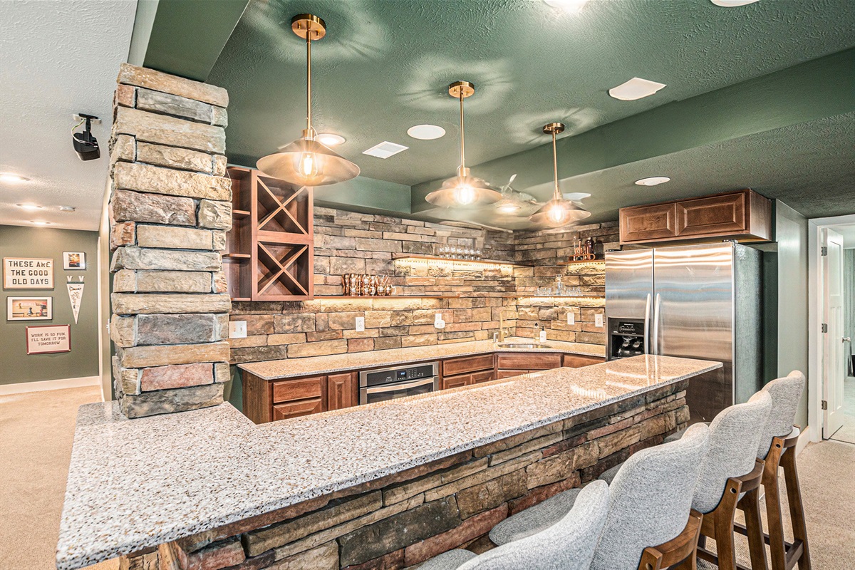 Your own downstairs hangout—barstools, a fridge, and a sink for easy entertaining.