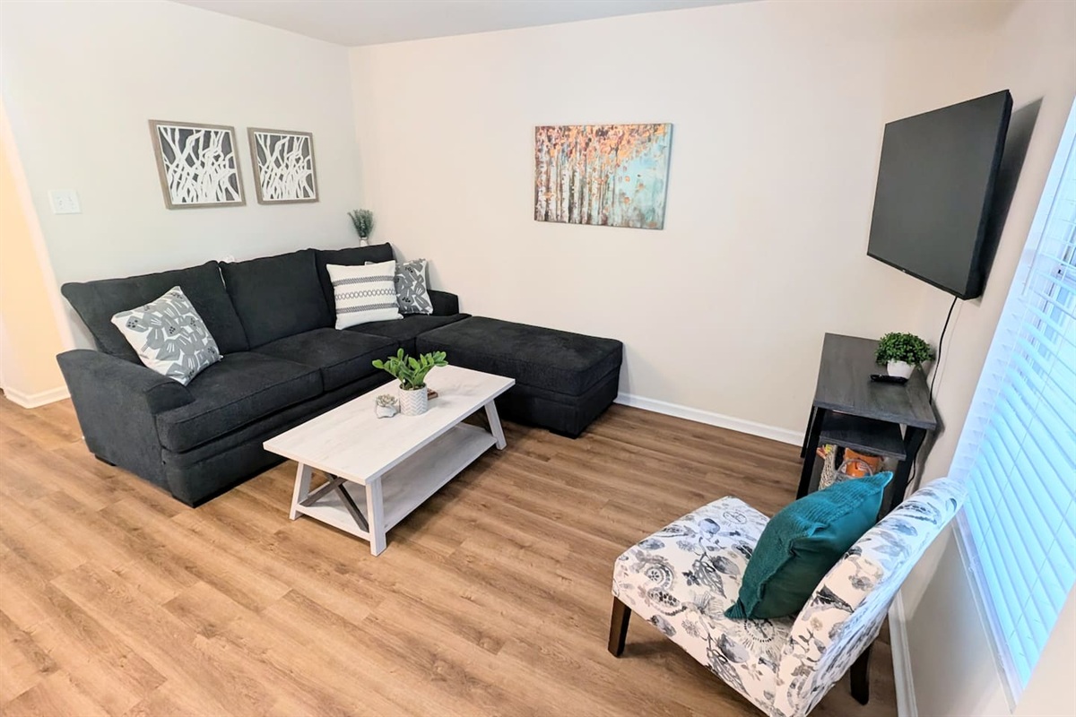 Plush sleeper sofa with ottoman offers plenty of seating options in this cozy living room. 