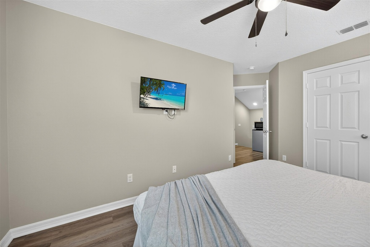 Guest bedroom with Roku TV and closet space — comfort for everyone.