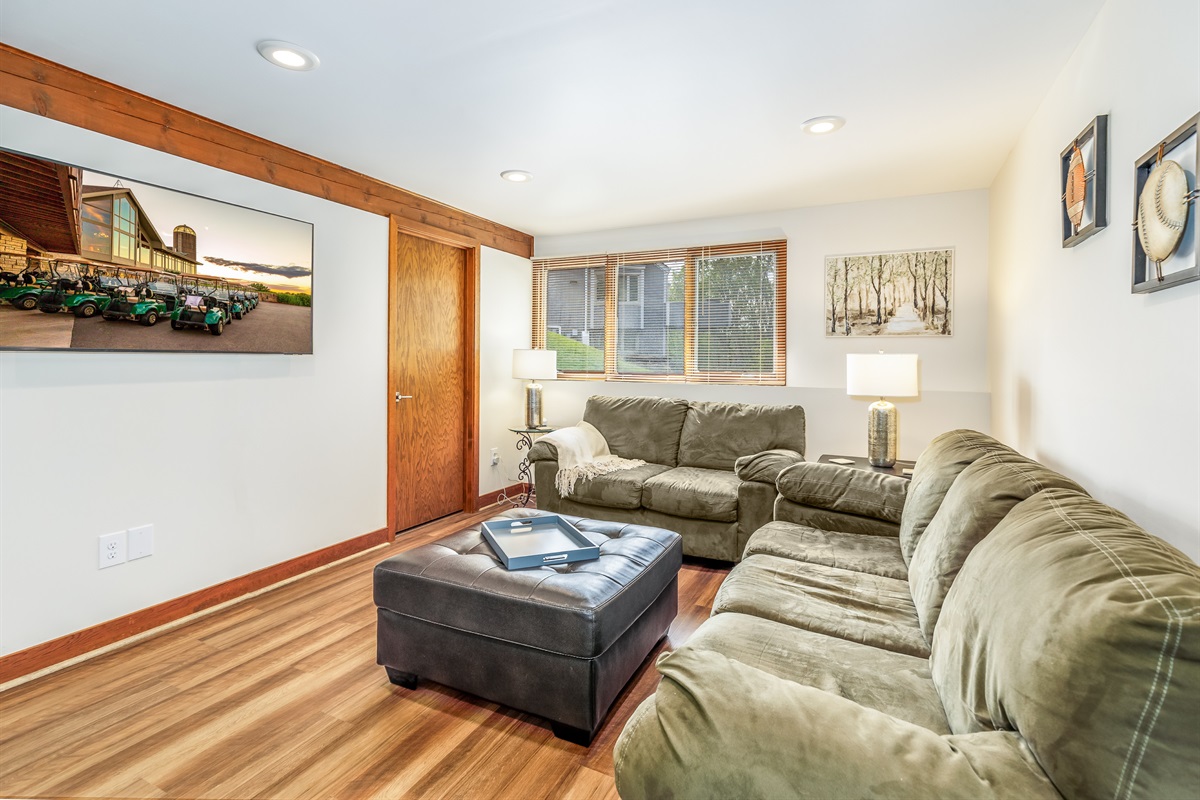 Lower-level living room with a Smart TV and comfy couches.  Store your drinks in the beverage refrigerator. 
