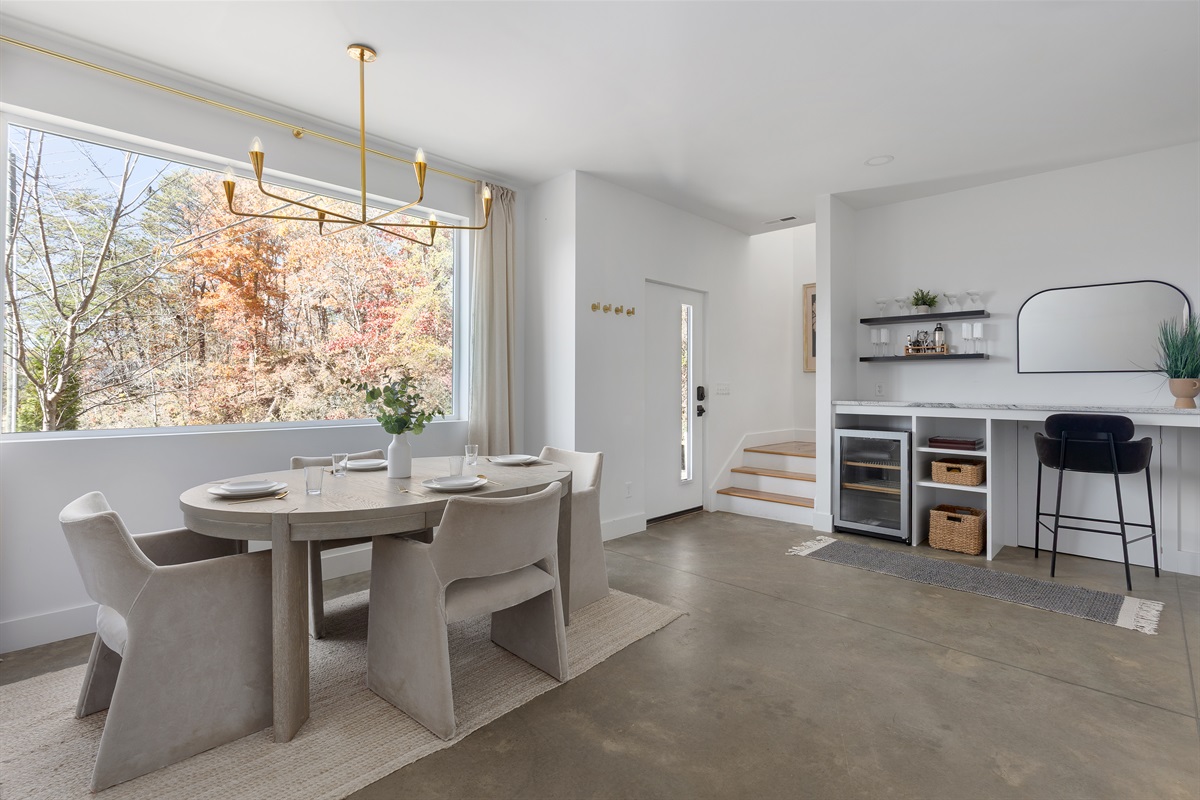 {Gathering Space} A cozy, light-filled lounge framed by treetop views—designed for slow mornings, game nights, and effortless togetherness.