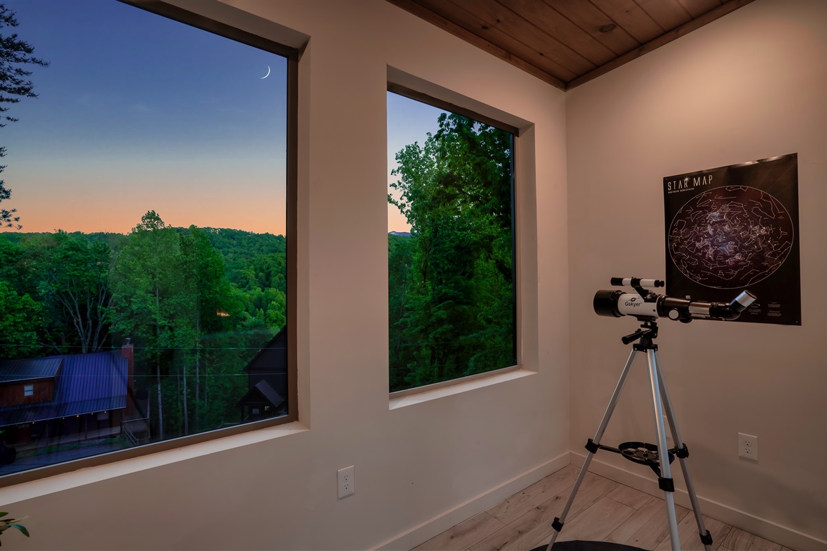 Telescope on the twilight terrace to look for bears in the mountains or stars in the sky