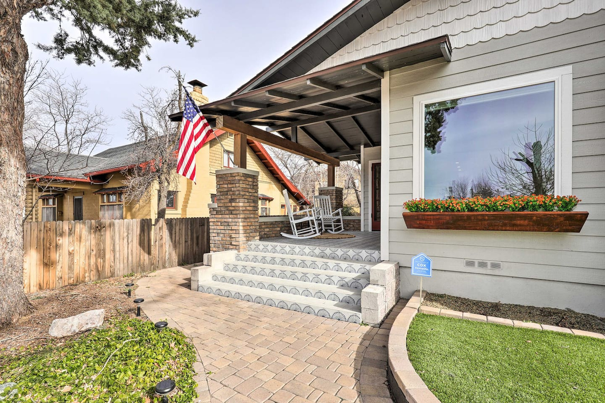 A patterned brick path leads you up to a porch made for slowing down.