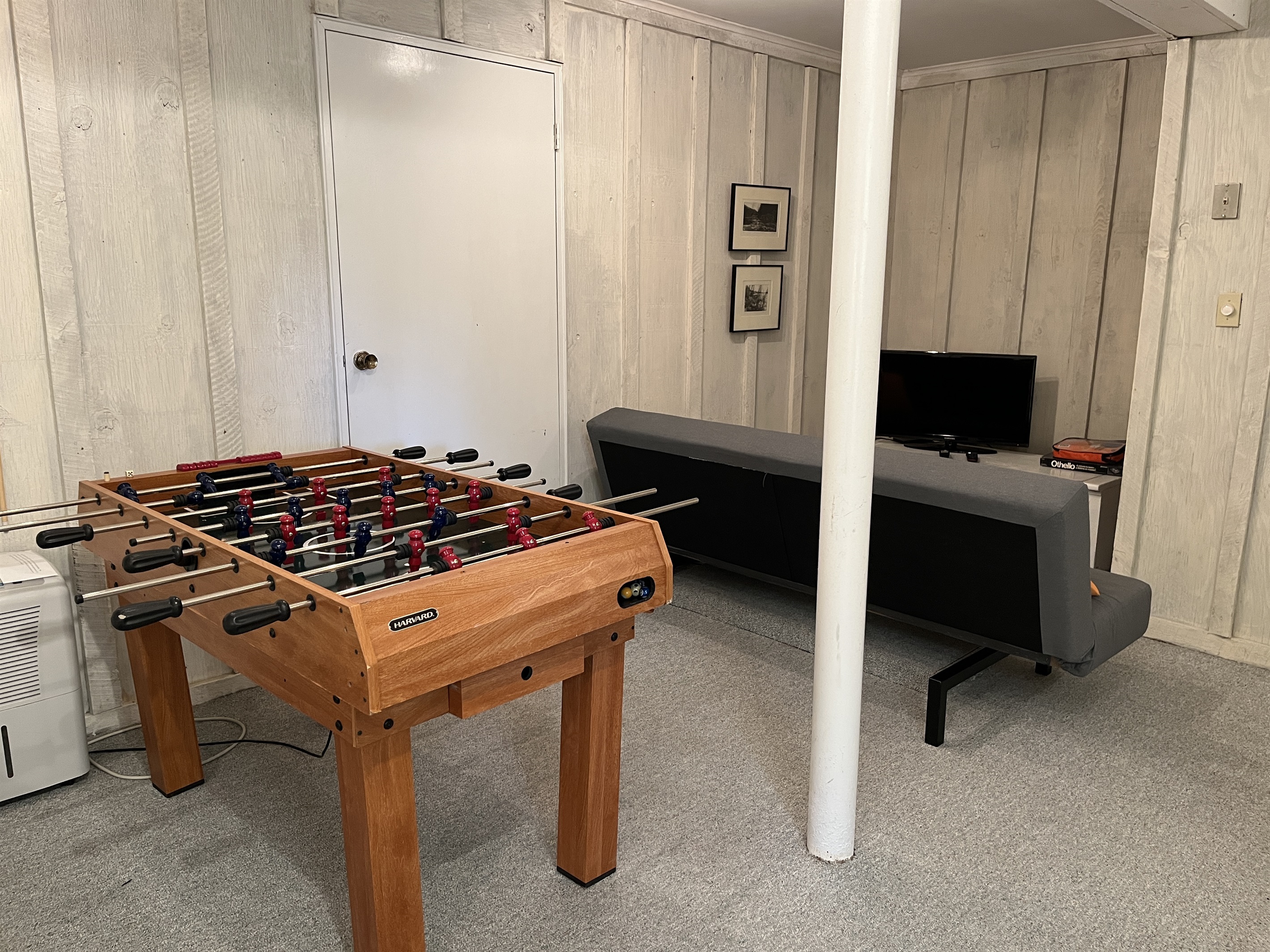 Lower level game room with TV and extra bed