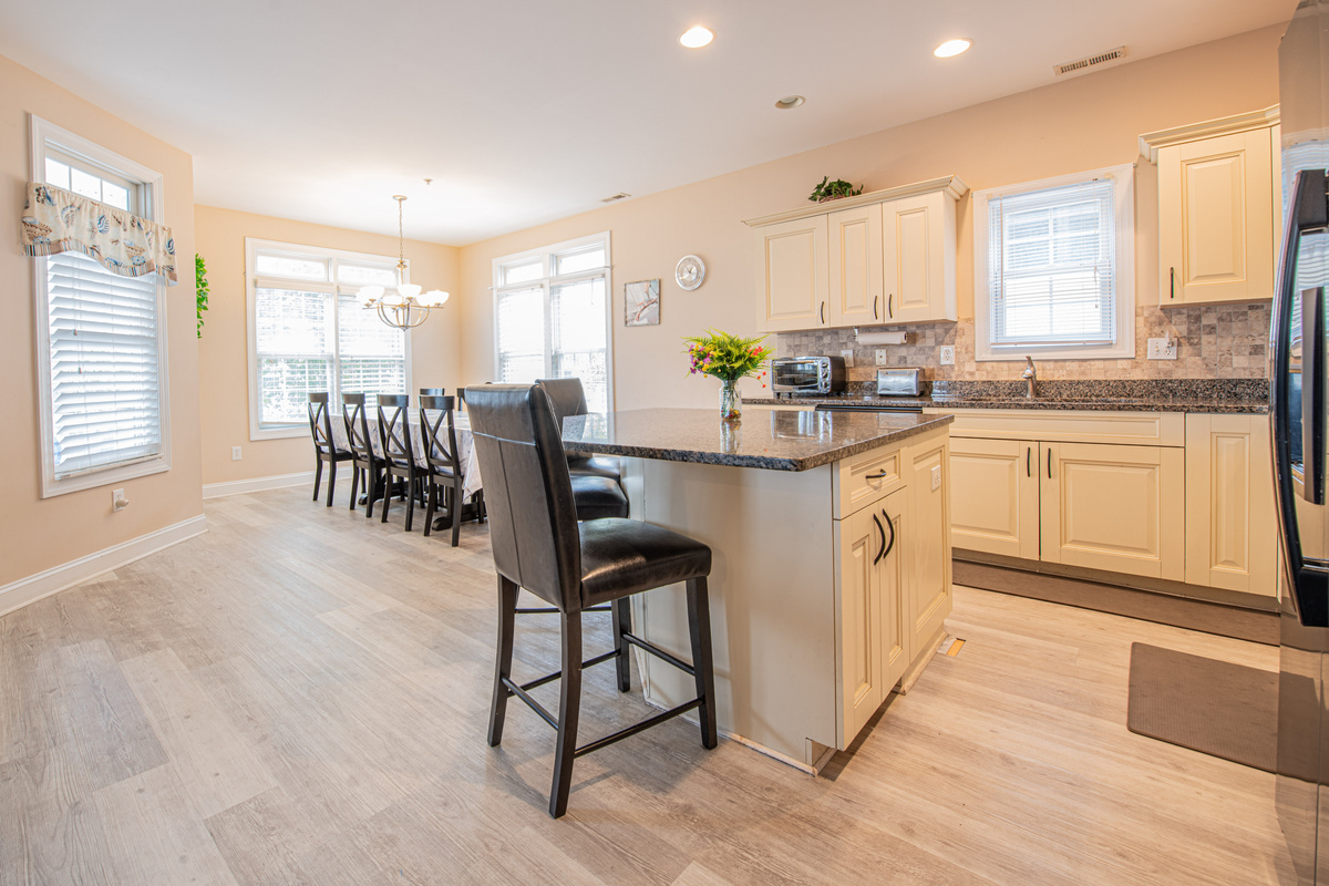 Open-Concept Kitchen and Dining Area with Center Island Bar Seating
