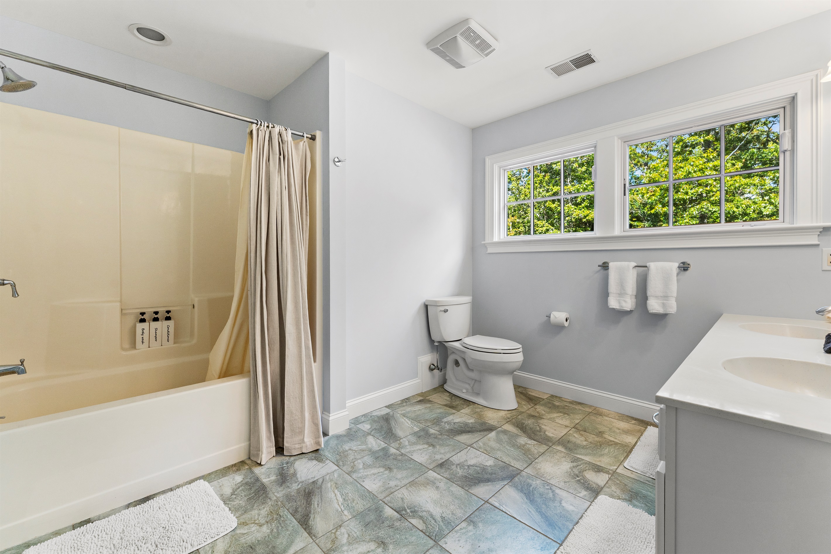 Upper-level shared bathroom with a full tub