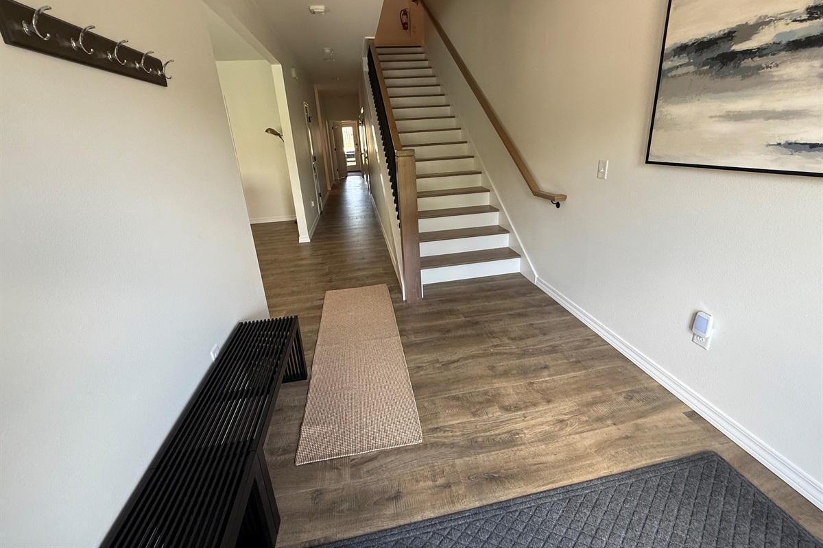 Hallway. Stairs to second floor. Hand stained steps and railings. 