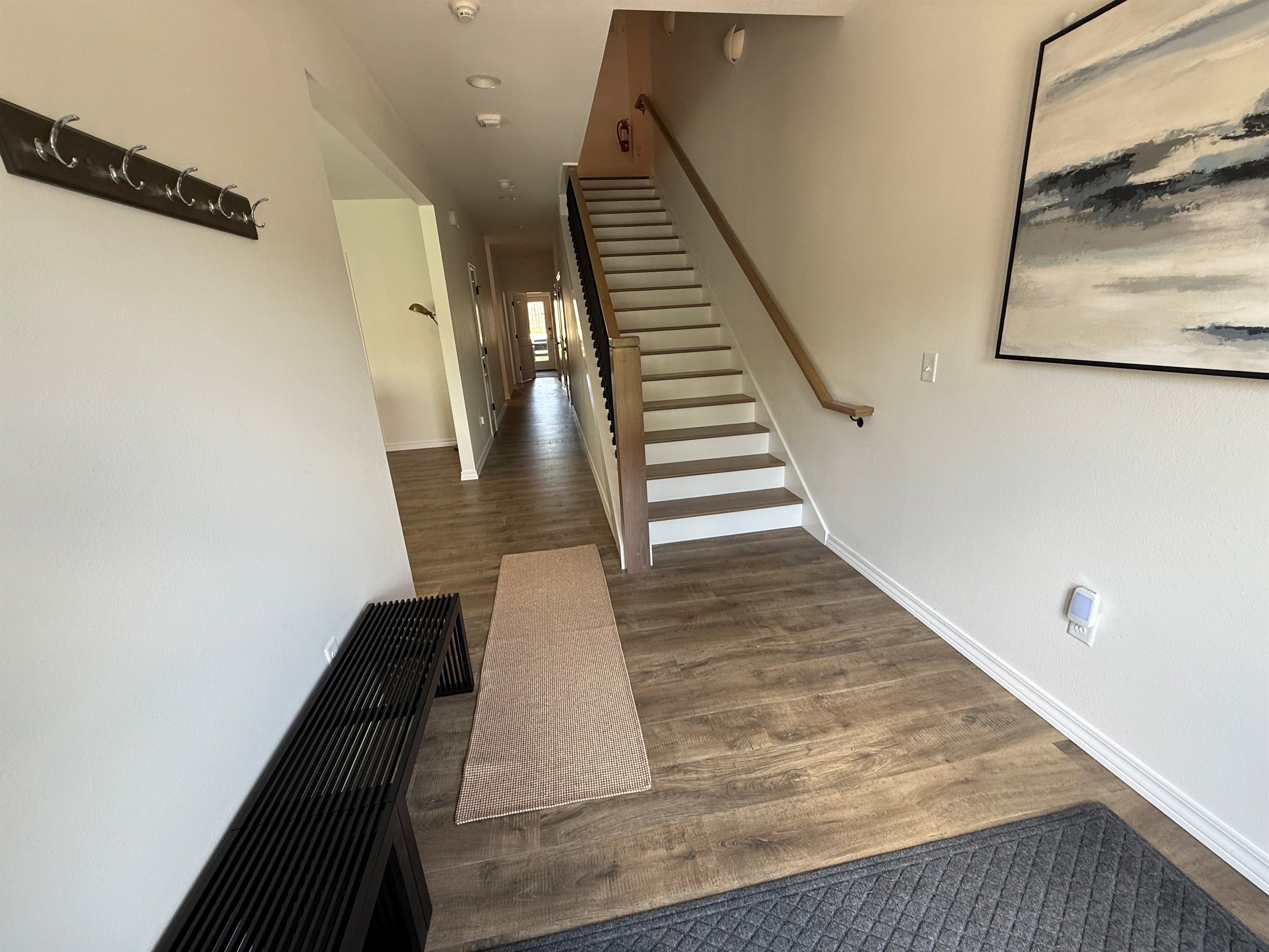 Hallway. Stairs to second floor. Hand stained steps and railings. 