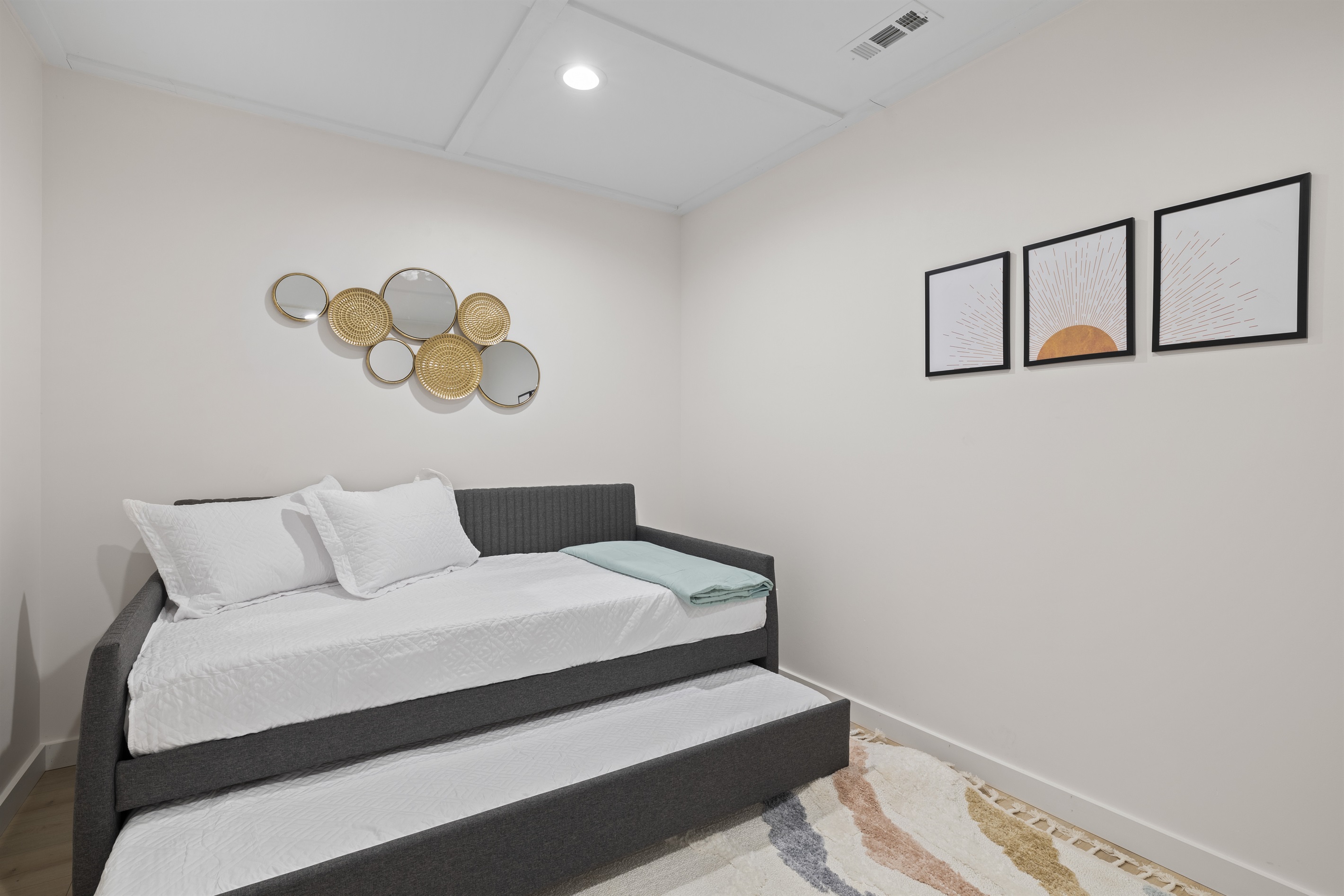 Bedroom #4:  This bedroom features a sleek and modern design including a comfortable daybed with plush pillows and a cozy throw blanket for added comfort.  