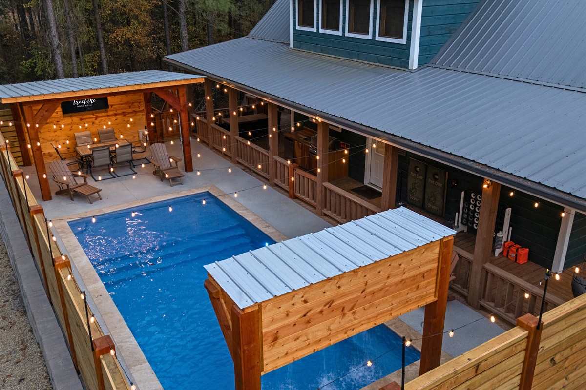 This wide view highlights the full pool setup, complete with plenty of seating and space to enjoy the outdoors.