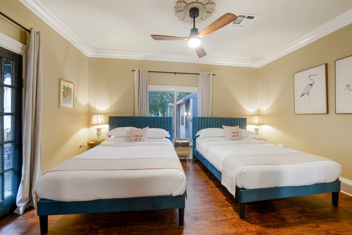 Spacious bedroom with two queen beds, top-rated linens, and inviting ambiance.
