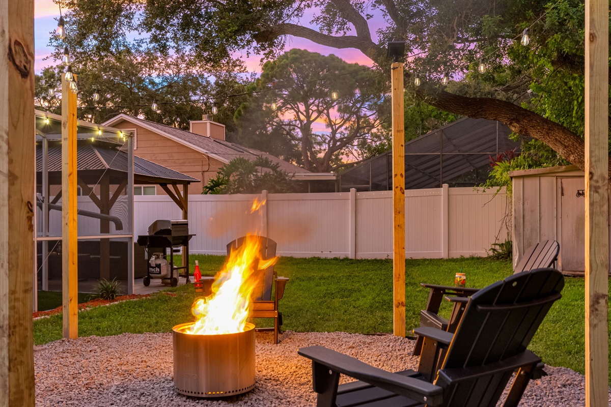 Unwind with a drink, roast some treats, and enjoy the night sky from this welcoming, beautifully lit fire pit corner.